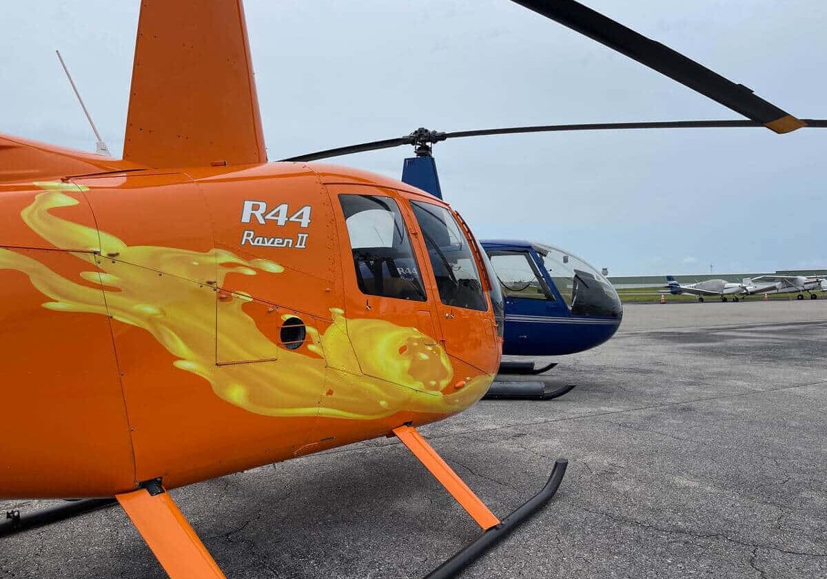 Orange & blue robinson helicopter standing